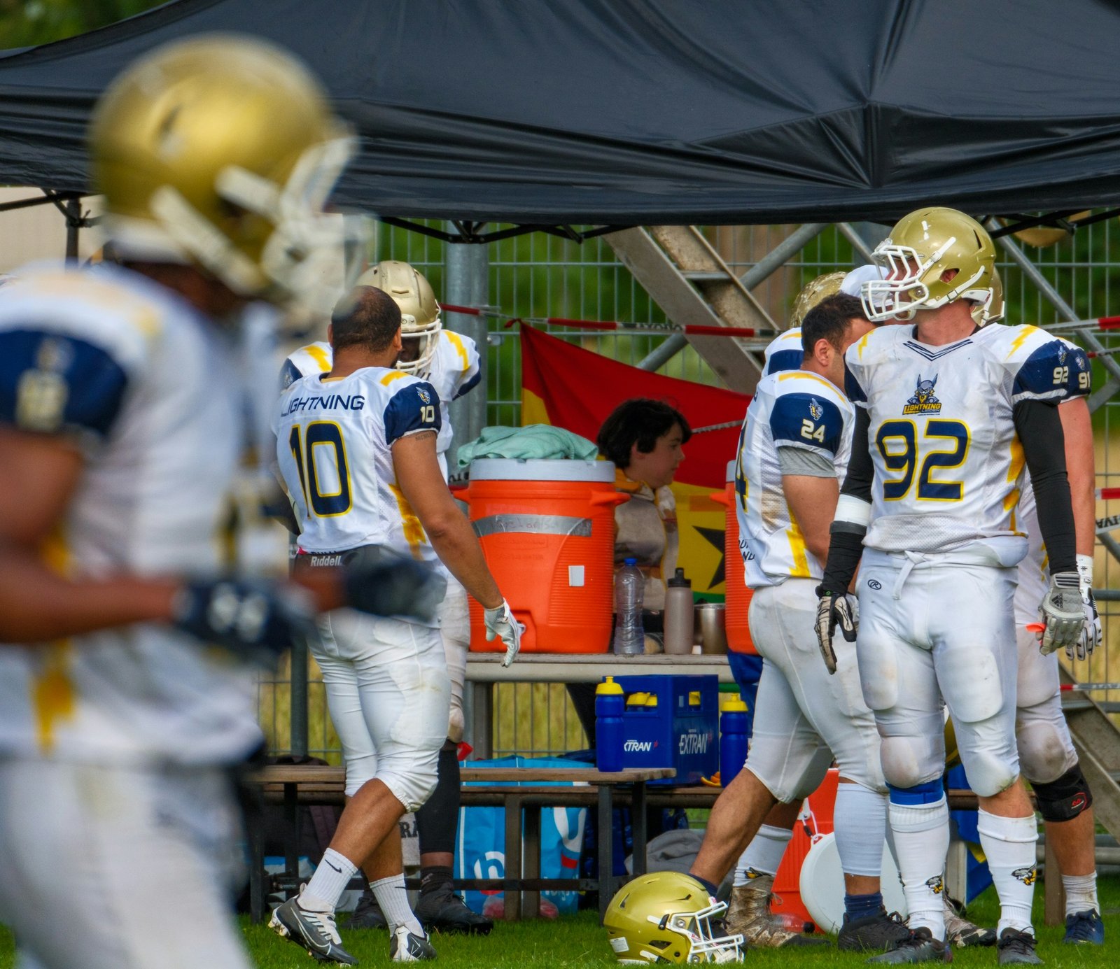 Helmeted American football players lined up on a green field