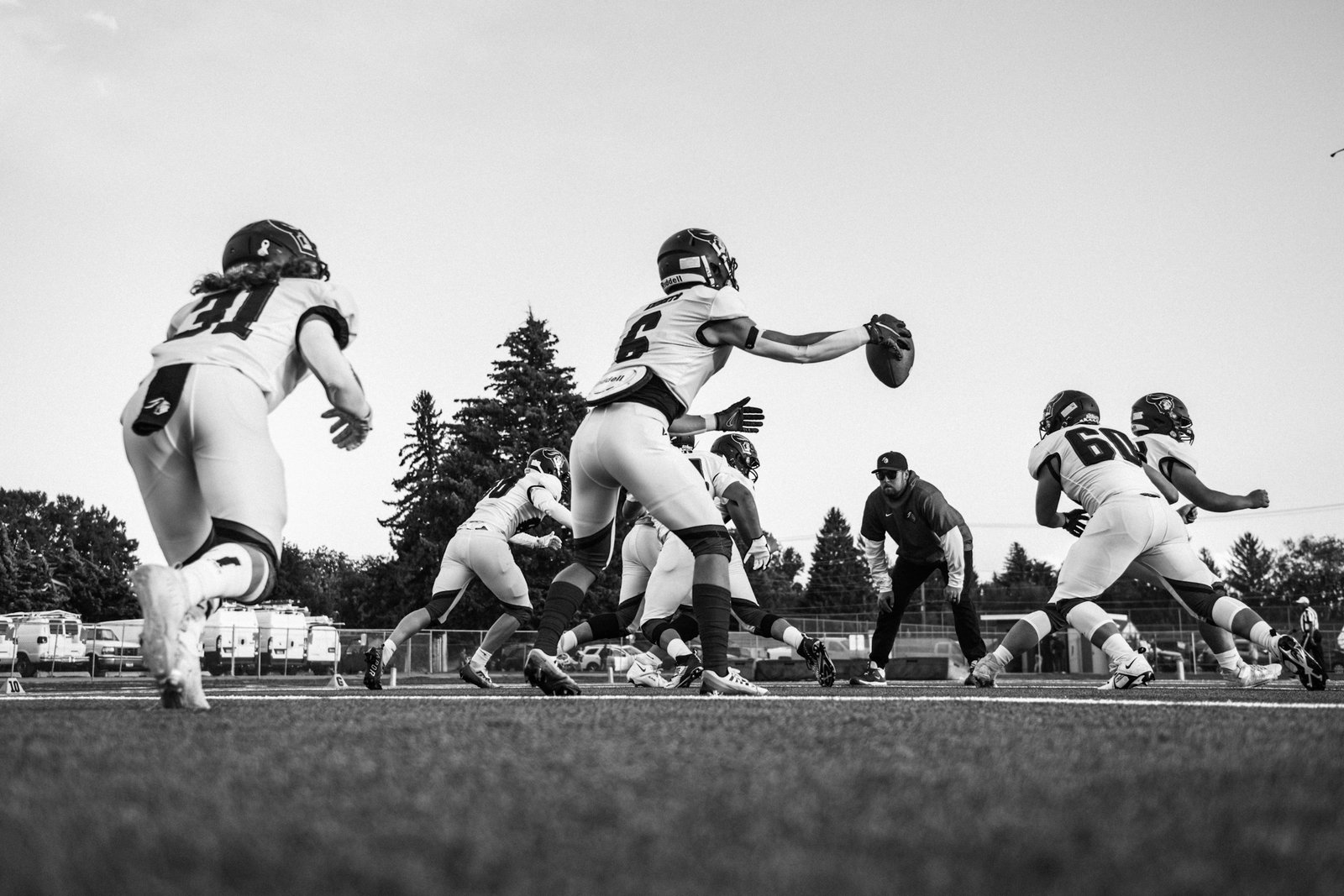 American football players competing on a marked field during a game