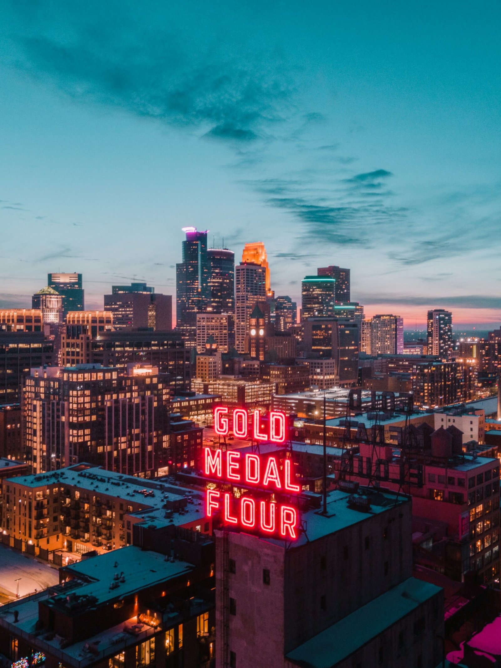 Minneapolis skyline glowing at blue hour after sunset